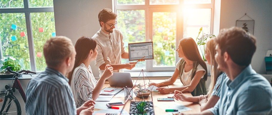 Man presenting QFD automated dispute management software to a group at a meeting.