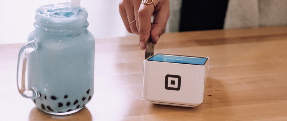 Person swiping card through card processor.